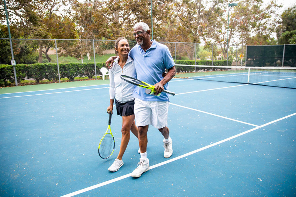 Confident couple playing tennis