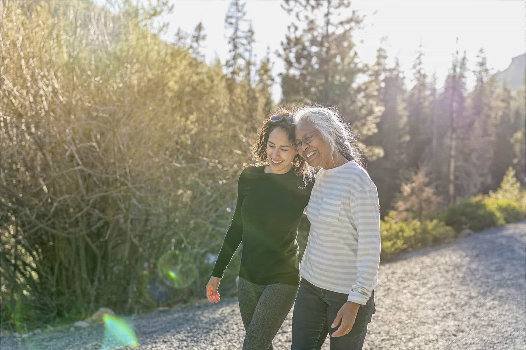 Portrait of beautiful mixed race senior woman spending time with her adult daughter outdoors