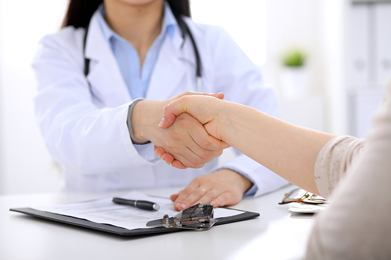 Doctor shaking hand of new partner